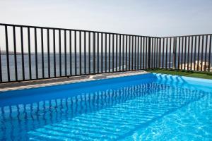 a swimming pool on a balcony with a fence at Relax Inn Hotel in St. Paul's Bay