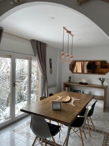 a dining room with a wooden table and chairs at Chalet Patty&Co in Encamp