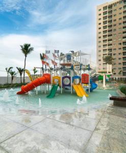 a water park with a slide in the water at Apartamento em Salinas - Exclusive Resort in Salinópolis