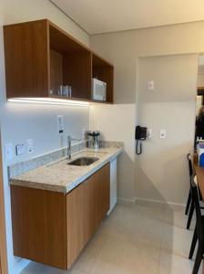 a kitchen with a sink and a counter at Apartamento em Salinas - Exclusive Resort in Salinópolis
