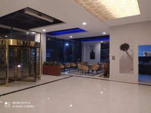 a lobby with tables and chairs in a building at İpsala Park Hotel in İpsala +88 photos