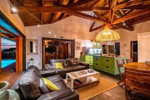 a living room with a couch and a table at KAZ PASSION - Villa Haut de gamme in Rivière