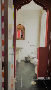 a bathroom with a toilet, sink and mirror at Porto Riad - Guest House in Porto