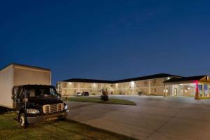 a truck parked in front of a building at night at Super 8 by Wyndham Sikeston/Miner Area in Sikeston