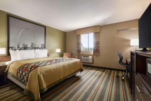 a hotel room with a bed and a television at Super 8 by Wyndham Sikeston/Miner Area in Sikeston
