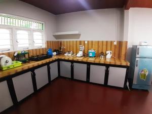 a kitchen with wooden counter tops and a refrigerator at Mutu villa in Dickwella