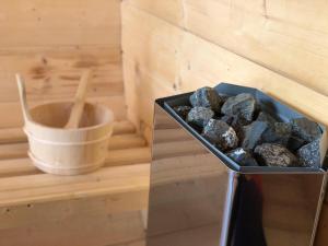 a container of rocks sitting on a table with a bucket at La 5 casute in Padis