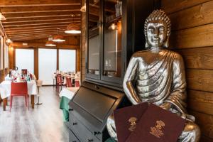 a statue of a buddha sitting in a restaurant at Hotel Palacio Muñatones in Muskiz