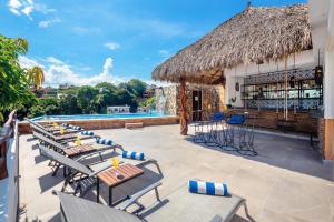 a resort with a pool and chairs and a bar at Casa Makawe ONLY ADULTS in Sayulita