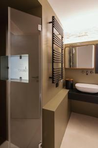 a bathroom with a sink and a mirror at Casa Conoscenti Suites in Bologna