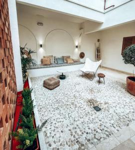 a living room with a couch and a chair at Casa du Soleil in Madrid