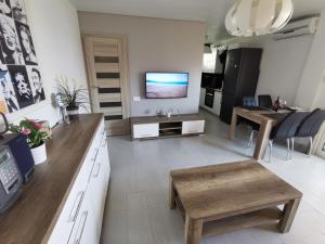 a large living room with a television and a table at SANTA SUSANNA Sea Dreams Appartement - Bord de mer in Malgrat de Mar
