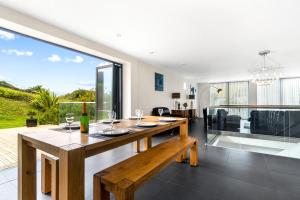 a dining room and living room with a large window at 1 Beachdown in Bigbury