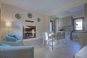 a living room and kitchen with a table and chairs at TORRE-BARBARIGA country house,3 beds,3 bath,parking in Stra