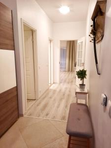 a hallway with a table and a bench in a room at Sand Beach Apartment in Narva-Jõesuu