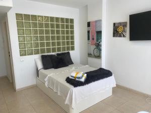 a bedroom with a bed and a television in it at Apartamento Alicante & sea view in Alicante