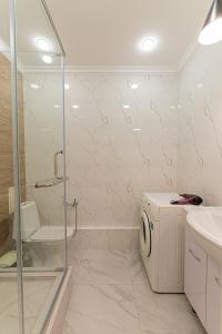 a bathroom with a shower and a washing machine at Tau Tengry in Astana +24 photos
