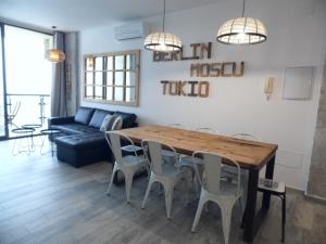 a living room with a wooden table and chairs at Puerto Marina in Benalmádena