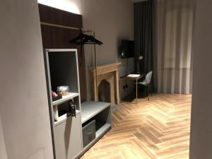 a living room with a tv and a fireplace at Materiaprima camere-rooms in Mantova