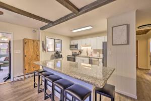 a kitchen with a counter and stools in a room at Cozy Poconos Ranch Home with Pool Access, Near Lake! in Gouldsboro
