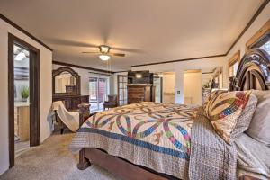 a bedroom with a bed and a desk and a chair at Cozy Home with Hot Tub - 11 Mi to Rainbow Falls in Woodland Park