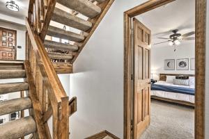 a staircase leading to a bedroom with a bed at Sunny Alpine Escape with Hot Tub and Mountain Vistas! in Fraser