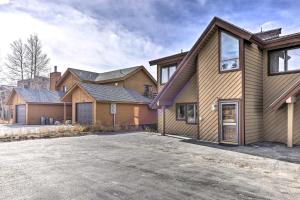 a large house with a driveway in front of it at Sunny Alpine Escape with Hot Tub and Mountain Vistas! in Fraser