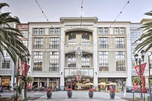 a large white building with palm trees in front of it at San Jose Loft in Heart of Silicon Valley! in San Jose