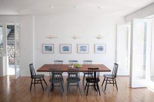 a dining room with a wooden table and chairs at Villa The Spot in Zaostrog