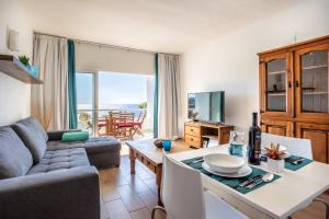 a living room with a couch and a table at The Blue Anchor SPECTACULAR SEA VIEW in Callao Salvaje