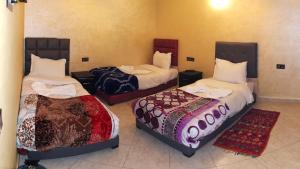 Postel nebo postele na pokoji v ubytování Riad Rayan's Guests