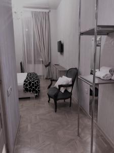 a bedroom with a bed and a chair and a desk at Brickwall Tbilisi-Tbilisi vibe in Tbilisi City