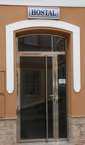 una entrada a un hospital con una puerta de cristal en Hostal Avenida, en Tabernas