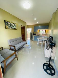 a living room with a couch and a kitchen at Furnished apartment Daily rental in Mactan