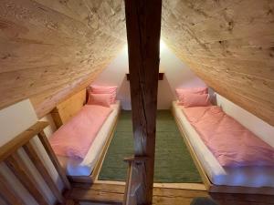 two bunk beds in a room with wooden ceilings at Schmiedgut Bad Aussee in Bad Aussee