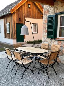 a picnic table and chairs in front of a building at Schmiedgut Bad Aussee in Bad Aussee