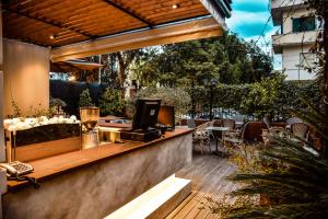 a patio with a bar with aperature at VH Broadway Tirana Hotel in Tirana