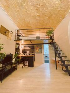 a loft bed in a living room with a staircase at CityLife Rome in Rome