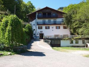 a large white house with a tree in front of it at Hostal Rural Onbordi in Lesaka