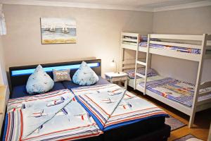 a bedroom with two beds and a bunk bed at Ferienhaus Fam_ Lemke in Bergen auf Rügen