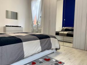 a bedroom with a large bed and a mirror at Casa Milena in Mestre