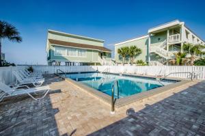 une maison avec une piscine en face d'une maison dans l'établissement Boardwalk D6, à Pensacola Beach