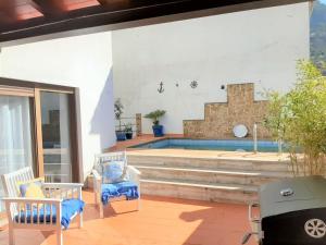 patio z 2 krzesłami i basenem w obiekcie LA CASA DE LA PINTORA DE CAZORLA,ideal para familias y grupos grandes w mieście Cazorla