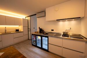 a kitchen with white cabinets and a counter top at Vakantiewoning Xalot in Tongeren