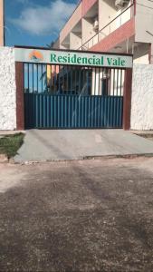 a gate in front of a building with a residential value sign at Casa de Praia Atalaia in Salinópolis