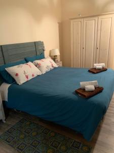 a bedroom with a blue bed with two towels on it at Casa Filemone in Syracuse