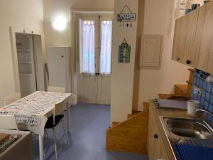 a small kitchen with a table and a sink at Casa Filemone in Syracuse