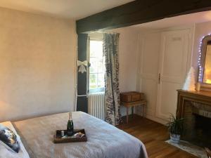 a bedroom with a bed and a window with a bottle of champagne at La petite duchesse Vernon Giverny in Vernon