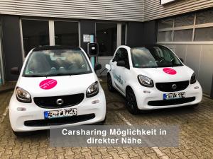 two white cars parked next to each other at 2-Zimmer City Apartment 57m² mit King Size Bett und Küche in Münster
