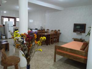 een woonkamer met een bank en een tafel met bloemen bij casa de mineiro in Tiradentes